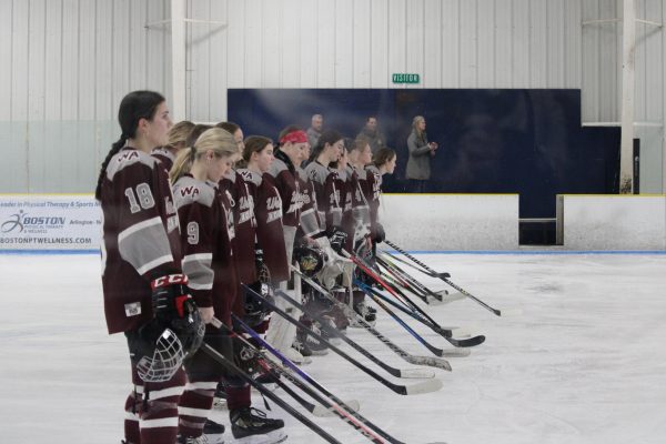 WA Girls Ice Hockey lines up on the rink during the National Anthem.