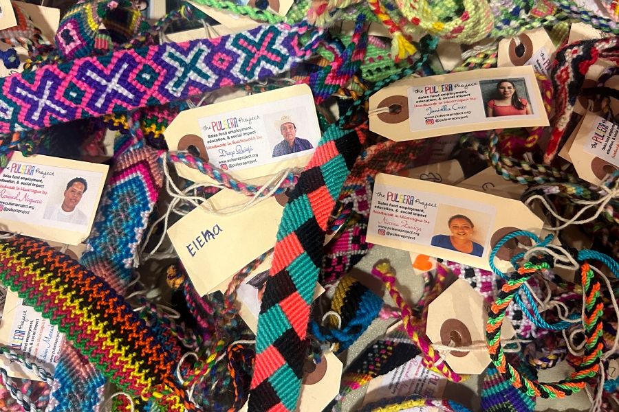 A spread of colorful, handmade bracelets lay for sale in the cafeteria.