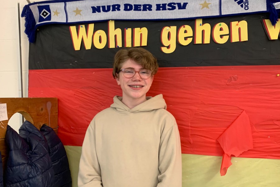 Scholarship winner Phoenix Daily poses for a photo in front of the German flag.