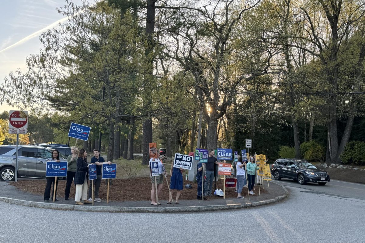 Westford+residents+hold+up+signs+at+the+Town+Election.