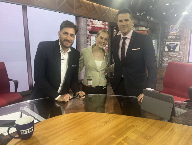 Schutt poses for a picture with the host of Get Up, Mike Greenberg and sports analyst, Alan Hahn.