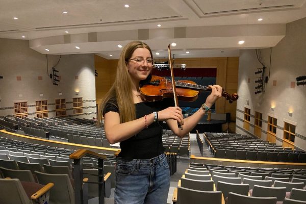 Amelia Margetts poses with her violin for a photo in the WA PAC.