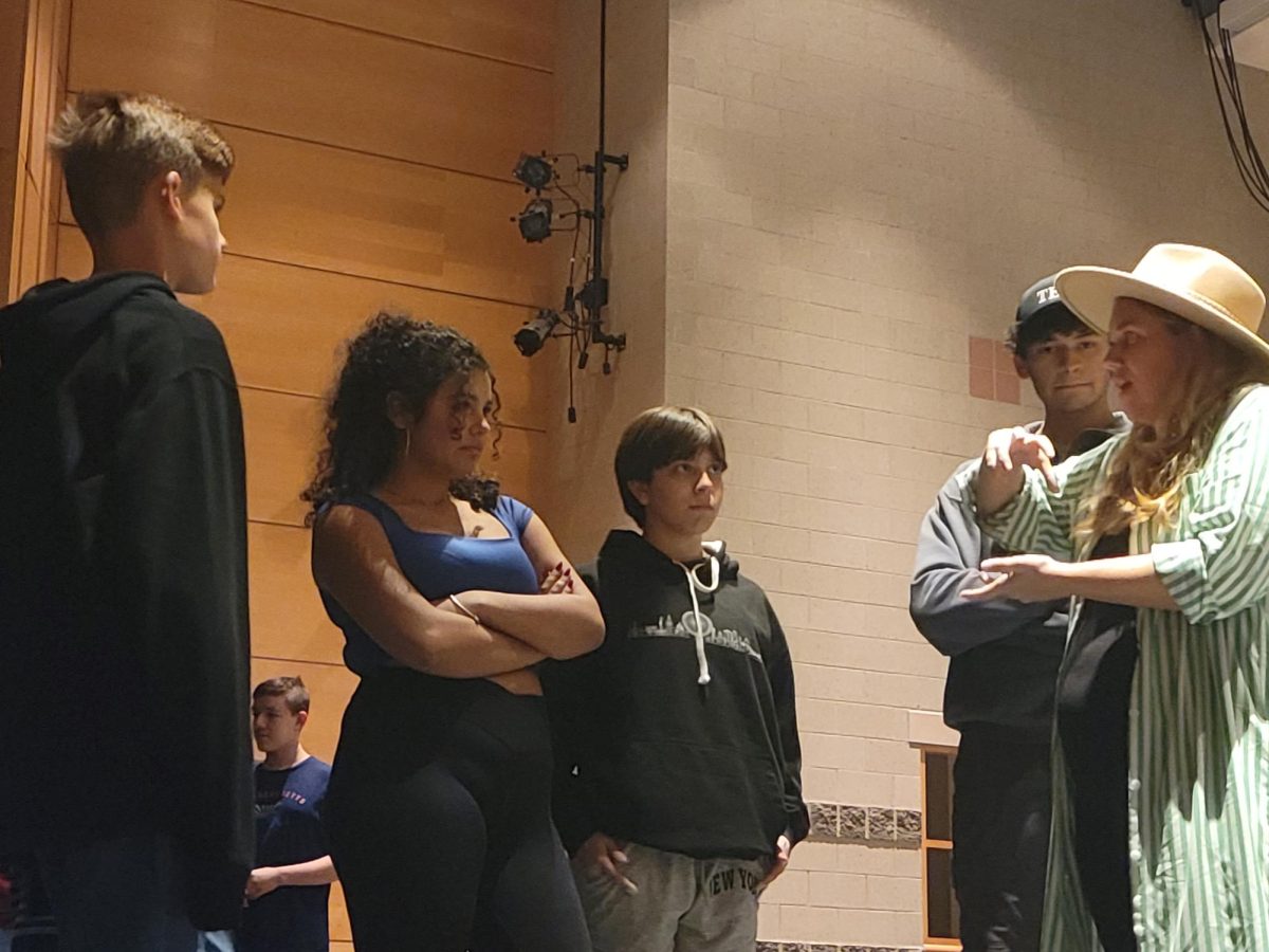 Sulka (right)instructs actors Holway (middle), Lee (left) and senior Aubrie Rose (middle-left) in their roles, Scorpius, Albus, and Delphi, respectively. One of the major focuses in Sulka's instructions is the use of emphasis to make phrases more comedic, serious, or intimidating.