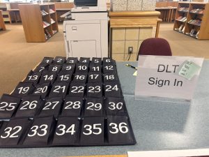 The DLT sign in table in the library, complete with a phone caddy or "phone jail."