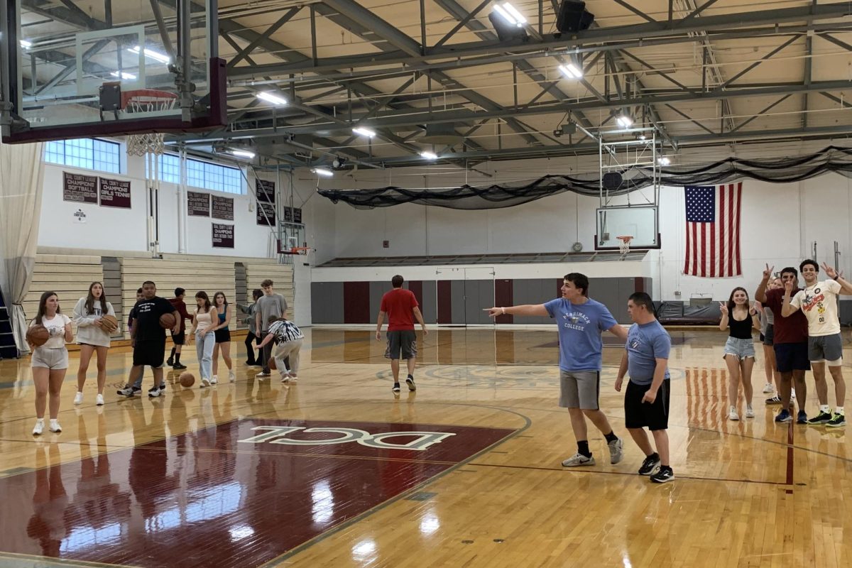 Members of the Unified Basketball team line up to practice shooting.