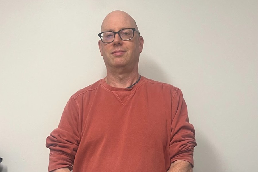 Jamie Milne poses for a photo in his office in the library.