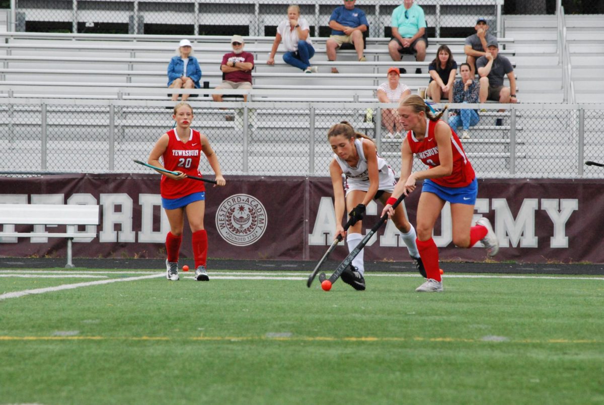 Sophomore midfield Emily Boneck closely follows a Tewksbury player. 