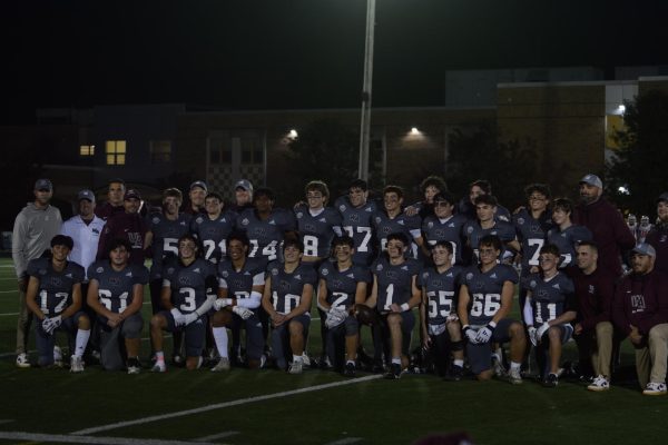 WA senior football players gather to take a group picture with their families. 