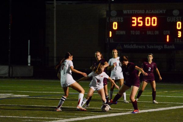 Amidst a current score of 0-0, Morris steals the ball from Waltham, aided by  (left to right) Keefe and sophomore Lyla Griffin.