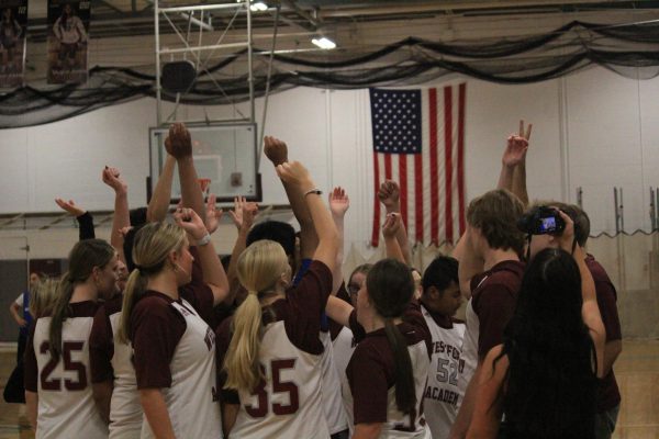 WA Unified Basketball huddles up before starting the game.