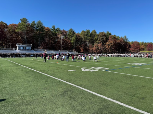 Students and staff scattered around the turf during the Spirit Rally. 