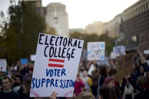 A protester's sign following Trump's election in 2016, referencing both the 2016 and 2000 elections where the candidate who won the popular vote lost the election. 

Provided by NBC news. 