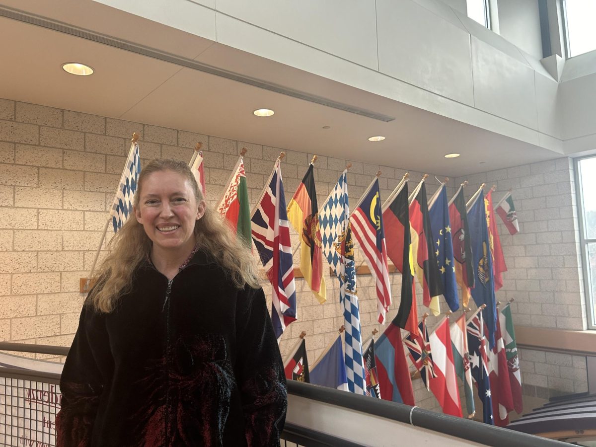 Wagner stands in front of the flag lobby, demonstrating the various origins of WA students. 