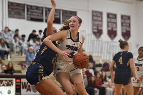 Junior Kaitlyn Pepin sprints to the basket, with a Shrewsbury player defending her closely.