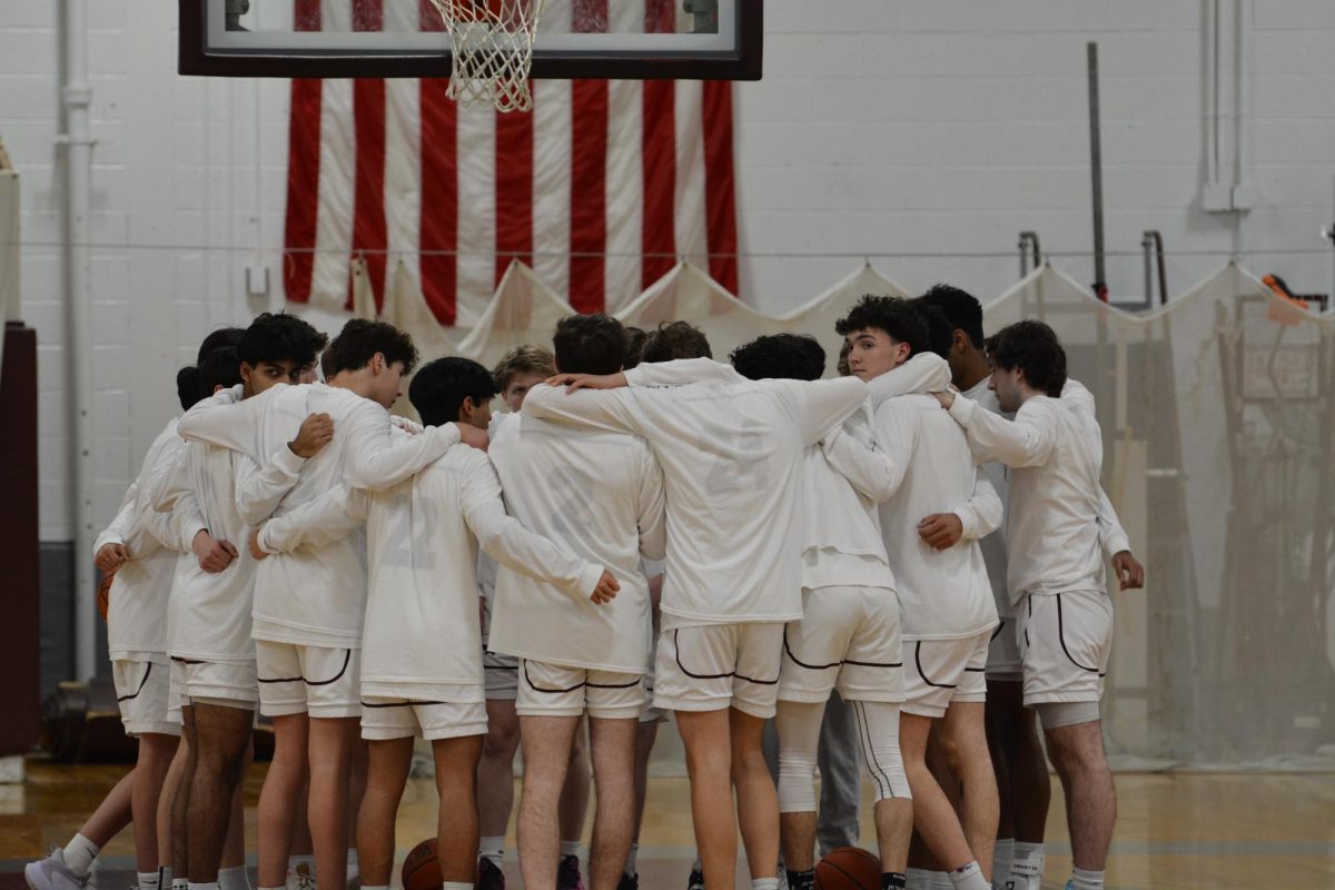 The WA Boys' Basketball team huddles up before the game.