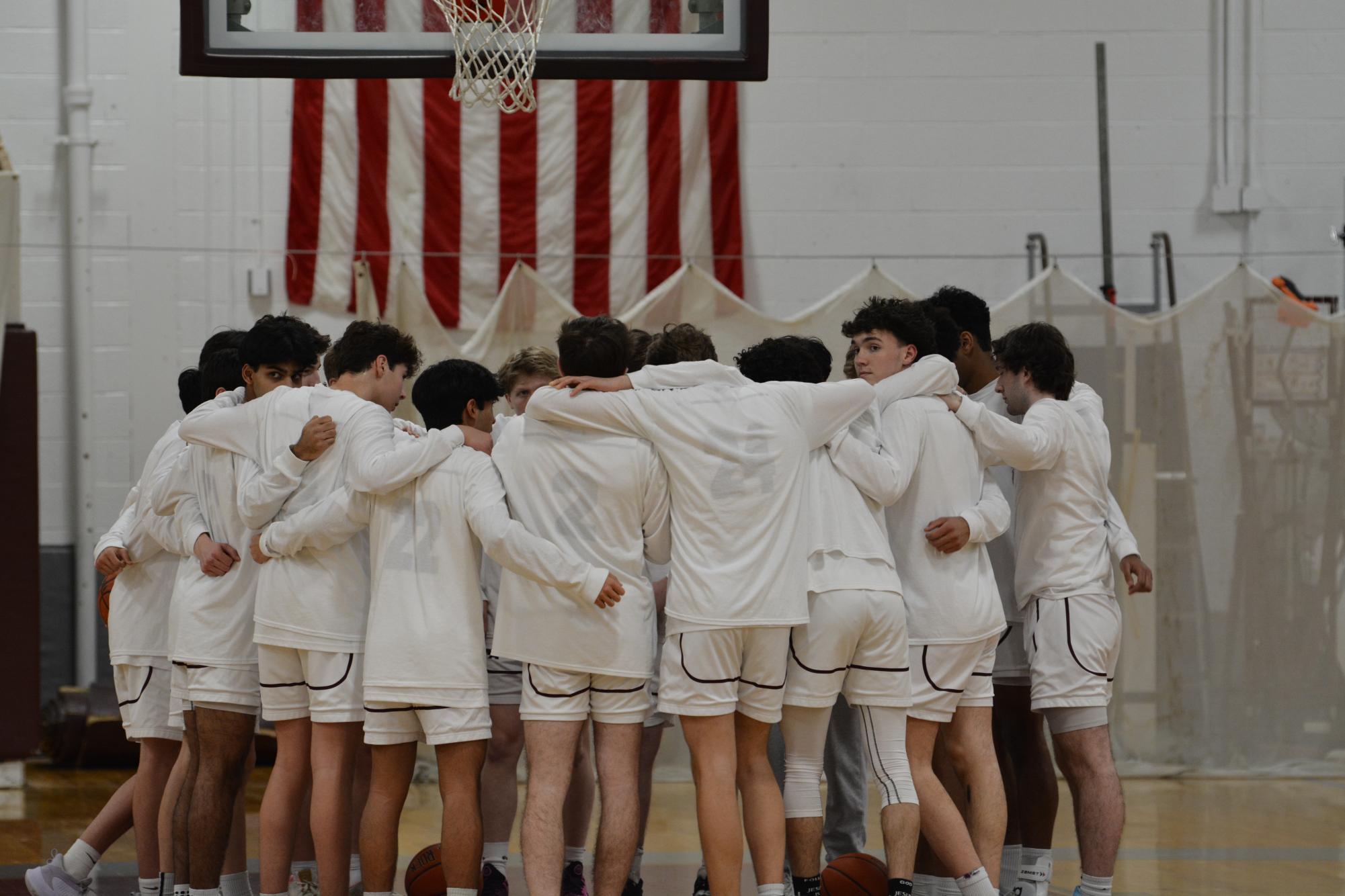 The WA Boys' Basketball team huddles up before the game.