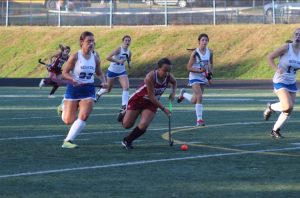 Lia Arevalo chases the ball as other players try to surround her