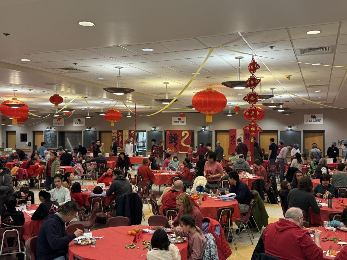 Attendees gather in the cafeteria to enjoy a festive meal together.