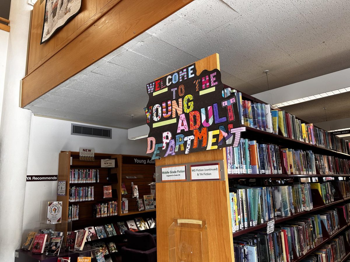 A colorful poster welcoming visitors to the Young Adult department at the J.V. Fletcher Library.