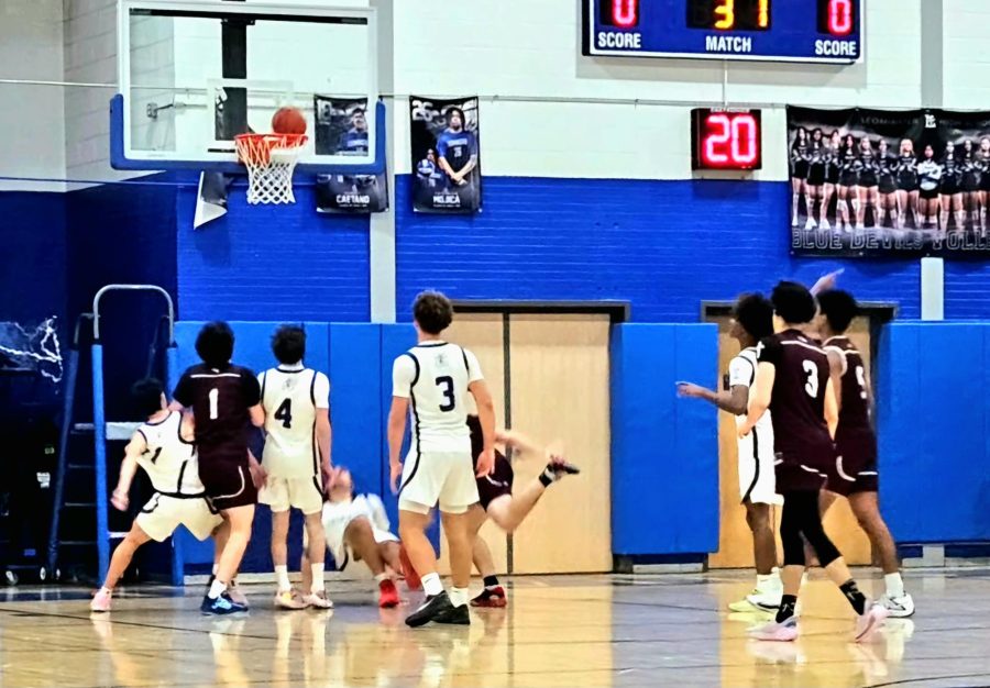 Senior Alex Wilson scoring a contested layup.