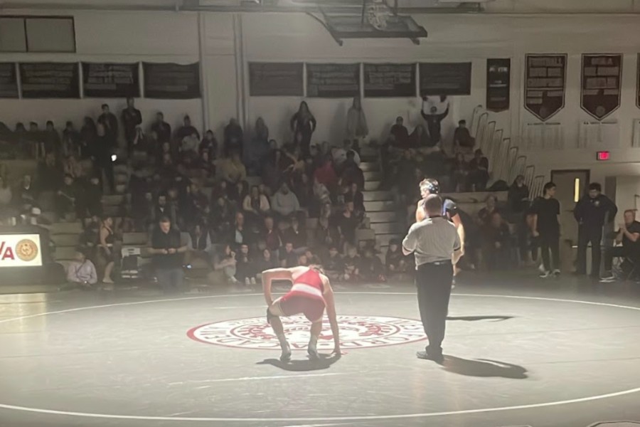 A WA athlete kneels down to recover after losing his match