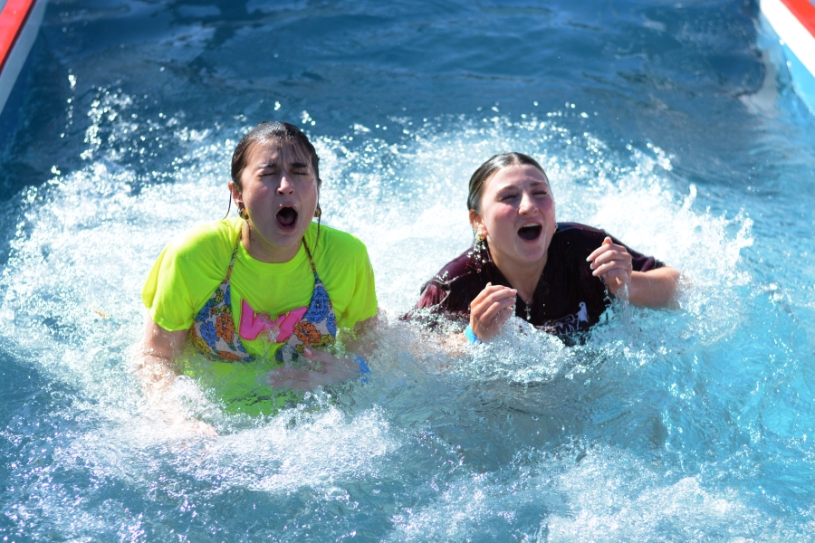 After jumping into the tank, sophomore Amelia Brown (left) and junior Eliana Donaruma (right) emerge shell-shocked by the ice cold water.