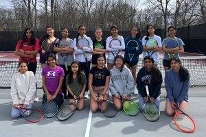 Returning players pose with their rackets on the second day of tryouts.