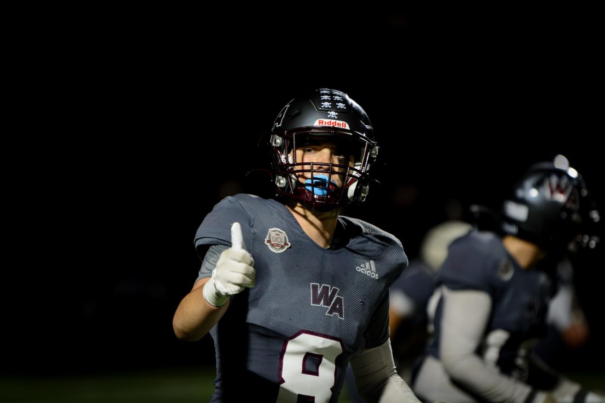 Senior captain Teddy Hirbour signals a thumbs up to his coaches on the sidelines.
