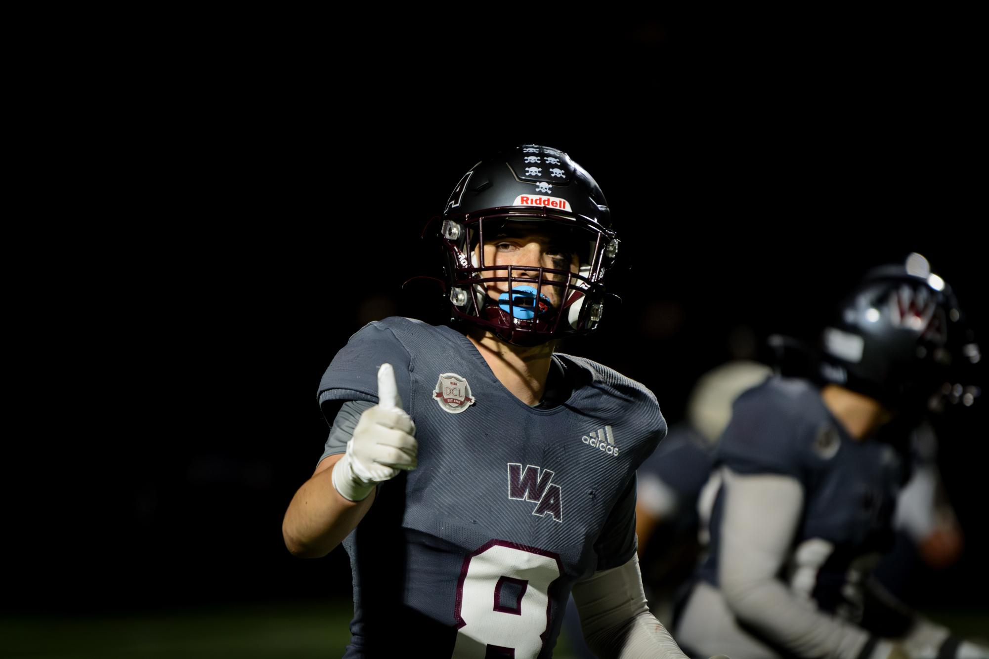 Senior captain Teddy Hirbour signals a thumbs up to his coaches on the sidelines.