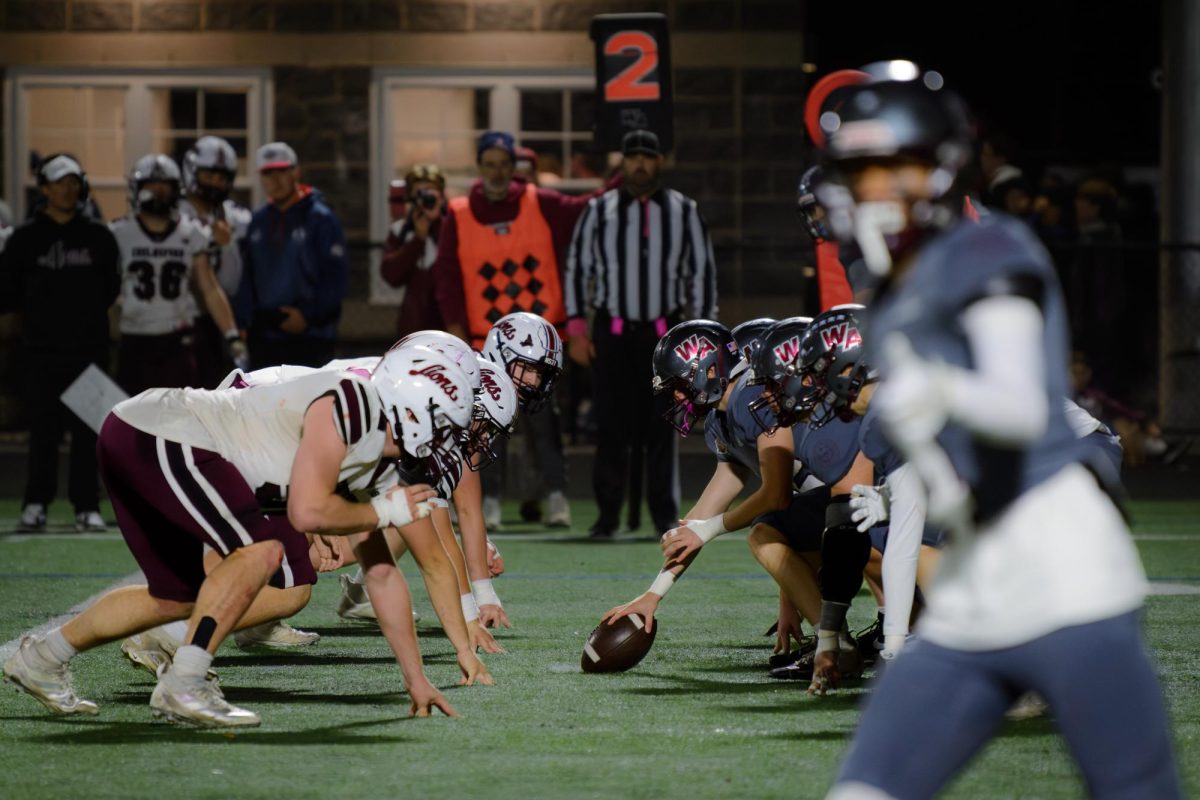 Westford Academy players ready themselves for a play.