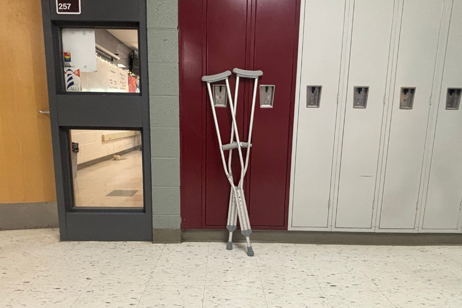 A student's crutches against a locker.