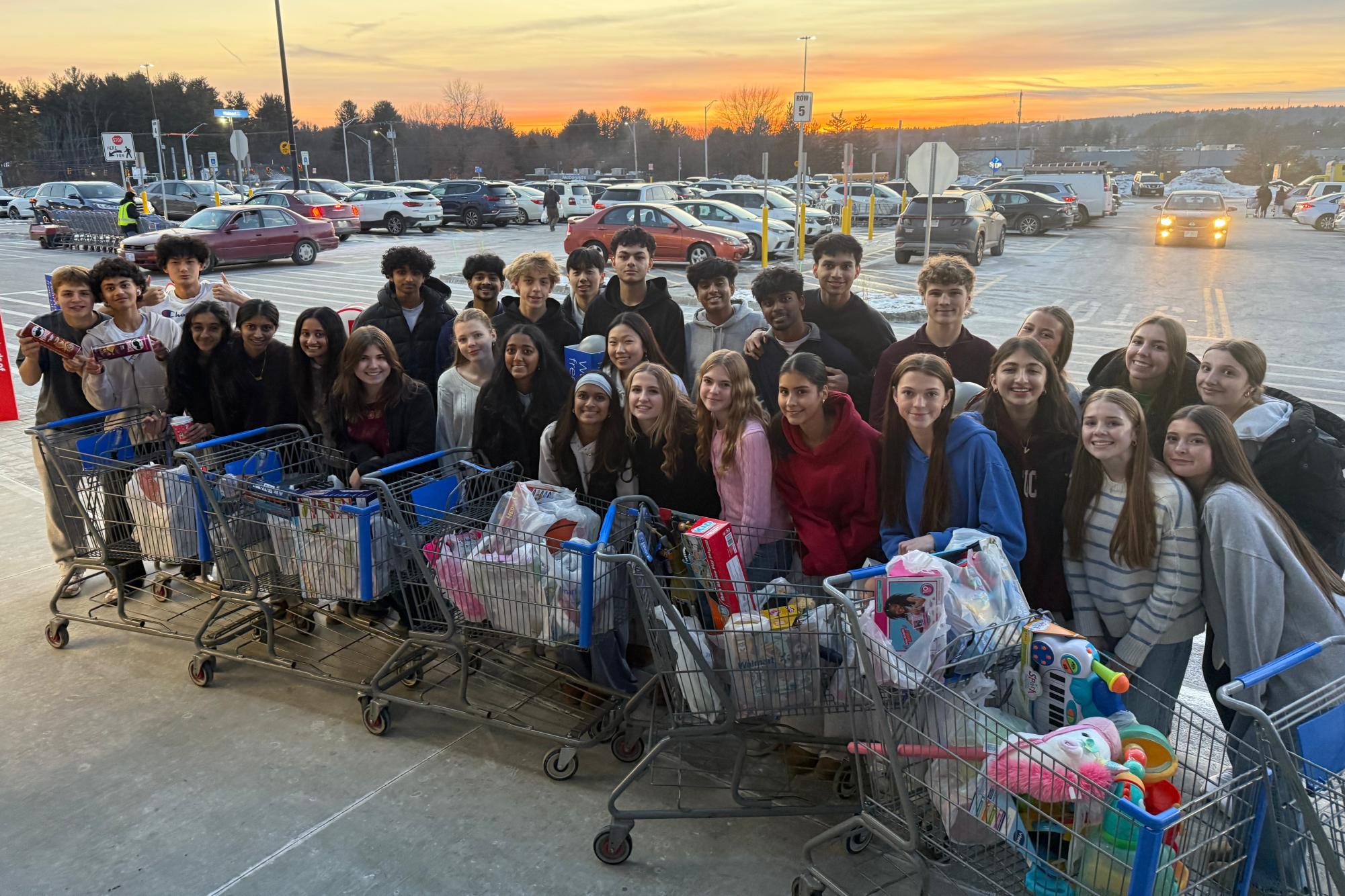 Surrounded by their shopping carts full of donations, STUCO members smile for a photo outside of Walmart.