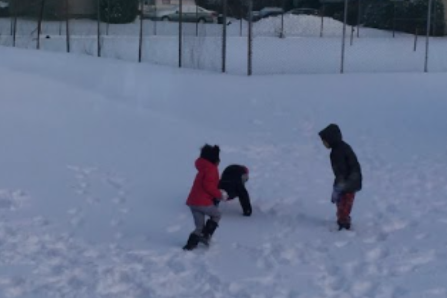 My neighbor friends and I playing in the snow together on a snow day in 2017.