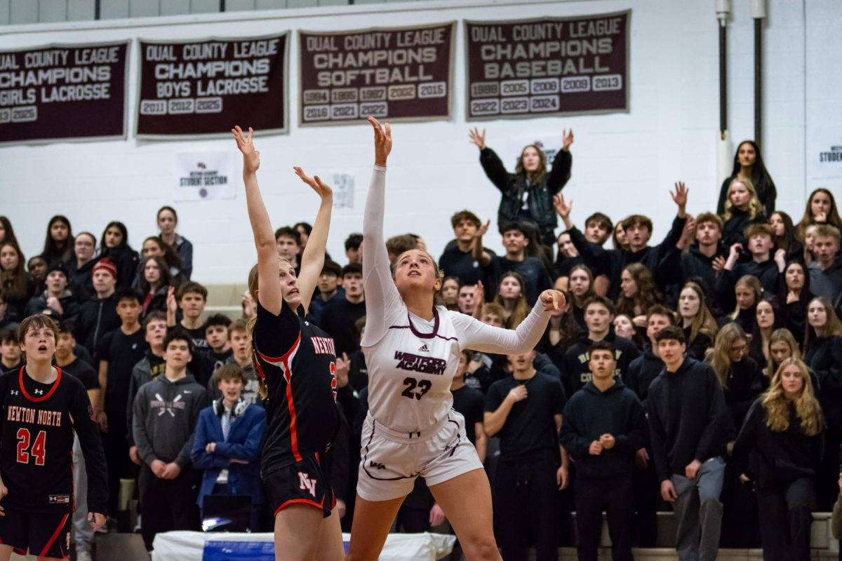 Senior captain Olivia Pillsbury puts up a floater as the WA student section watches.