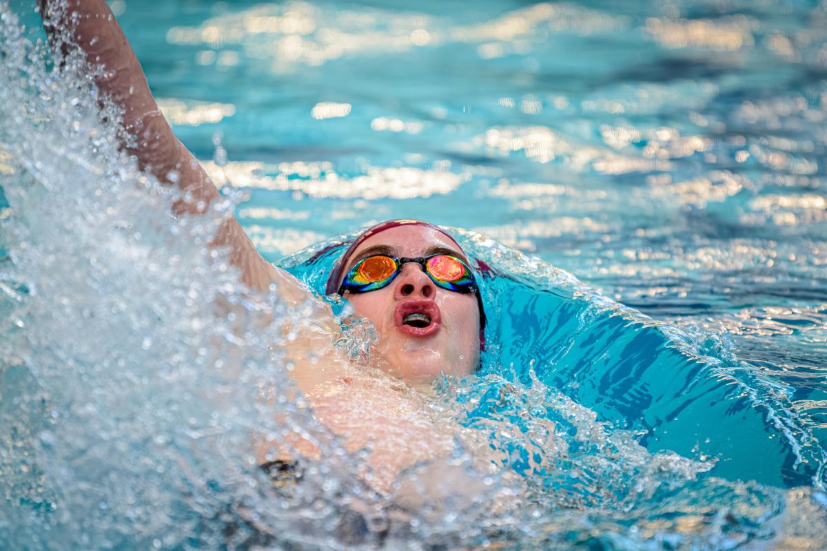 Sophomore Ethan Barrett propels himself backwards during the backstroke.