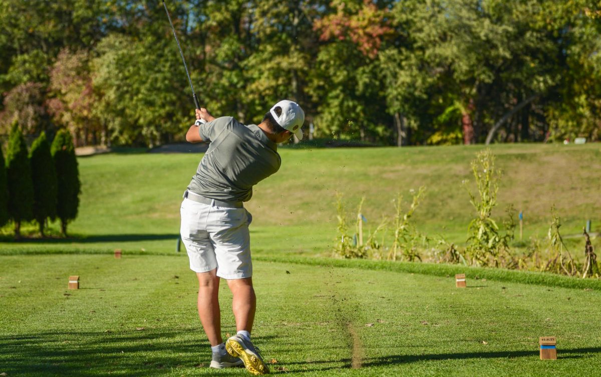 Li drives the ball at the first tee box.