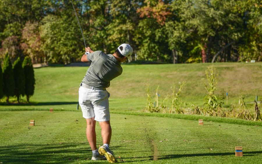 Li drives the ball at the first tee box.