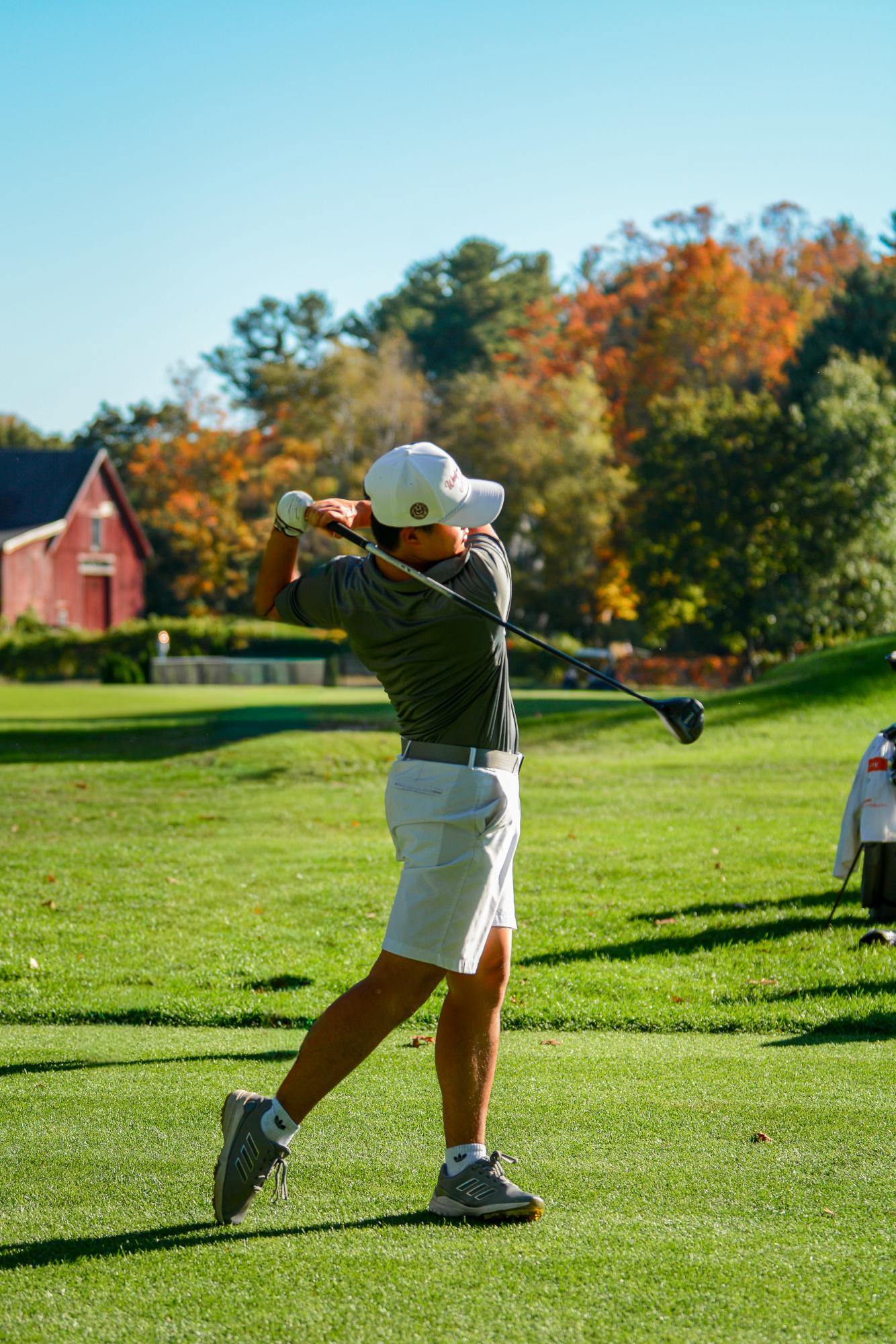 Li swings the ball through the fairway.