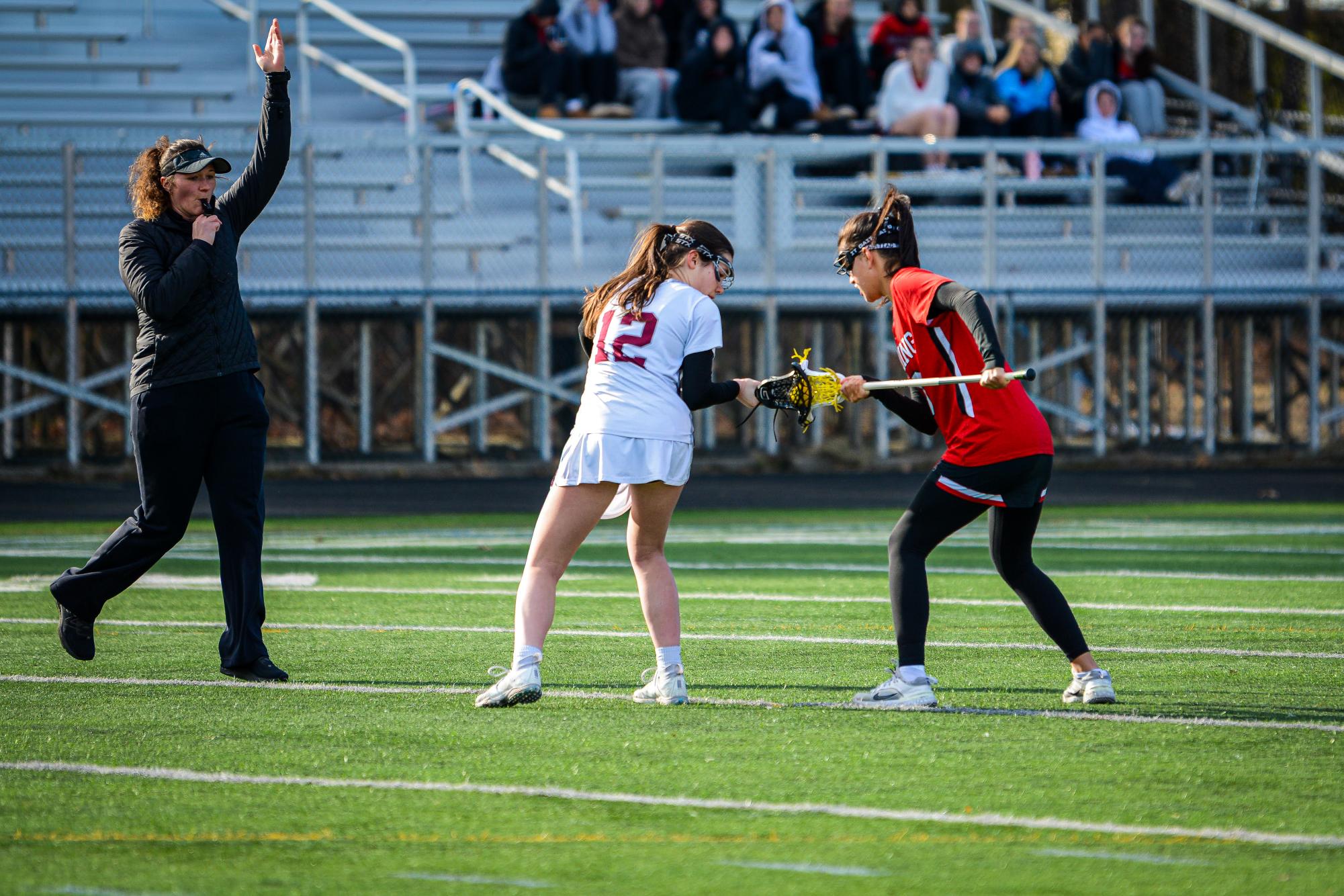 Senior captain Evie Weber takes the draw to start off the game, focusing intently on the ball. 