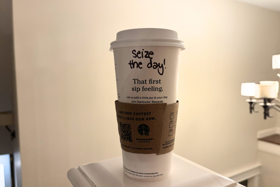 A Starbucks cup with the message "seize the day" written on it.