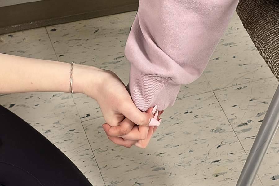 Two students holding hands.