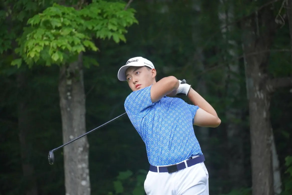 Li tracks the ball with his eyes after a swing.