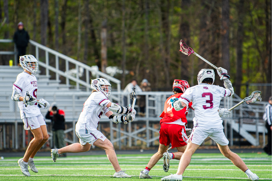 (Left to right) Guthrie, Burgess, and senior captain Peter Burns all defend the home net. 
